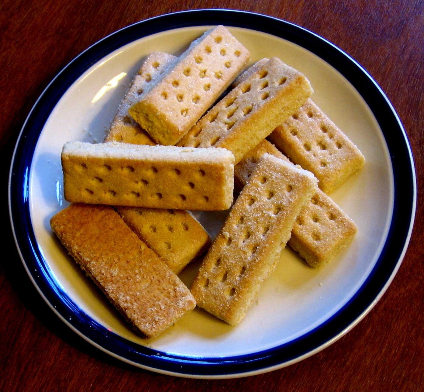 Shortbread fingers sprinkled with sugar on a plate